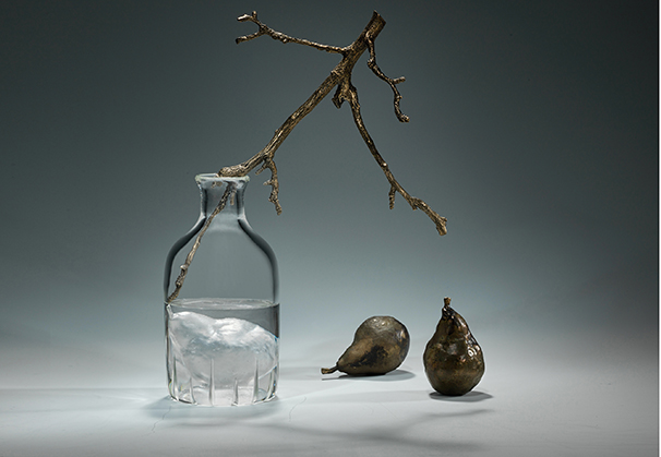 <i>Bottled Pear</i>, 2019; 20 x 13 x 5 inches; negative-core cast and blown glass, cast bronze with patina
