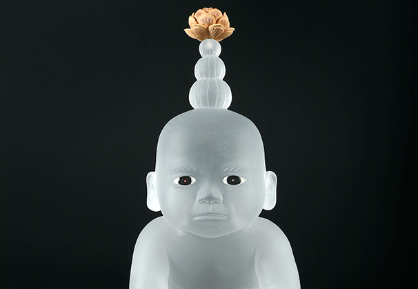 <i>Seated Baby With Mysterious Flower</i>, 2019; 18.5 x 13.25 x 13.25 inches; cast glass, inlaid glass eyes, boxwood, and wood stand