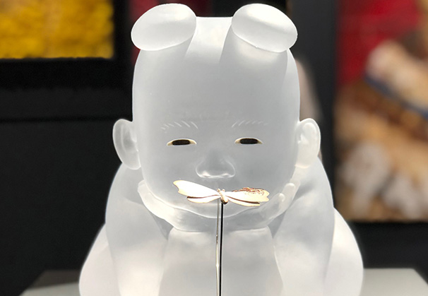 <i>Seated Baby</i>, 2019; 11 x 10 x 9 inches; cast glass, inlaid glass eyes, silver butterfly