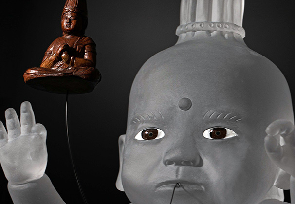 <i>Seated Baby of Mercy</i>, 2019; 24 x 11 x 14 inches; cast glass, inlaid glass eyes, antique Buddha