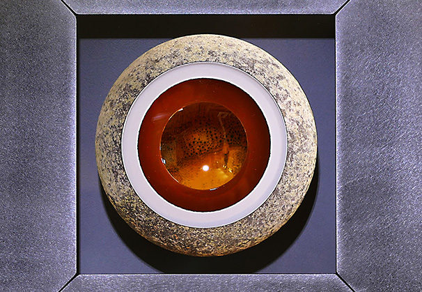 <i>Geode with Traveler</i>, 2021; 11.5 h x 11.5 w x 4.25 d (inches); original image, screen-printed kiln-fired enamels, blown, sandblasted, mirrored glass, steel with patina and paint

