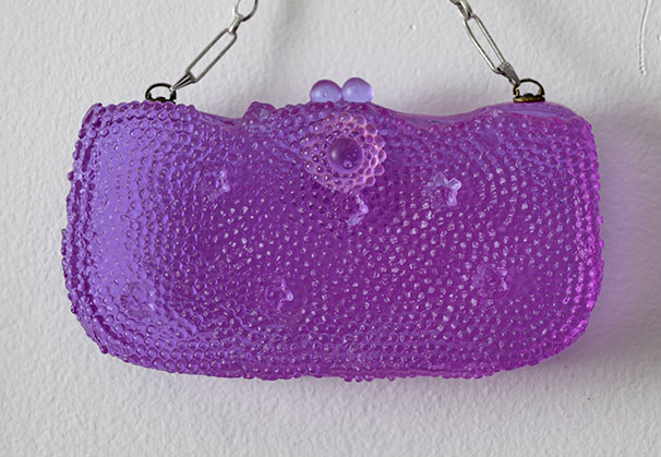 <i>Purple Beaded Purse</i>, 2026; 3 x 6 x 1 inches; cast glass, vintage chain