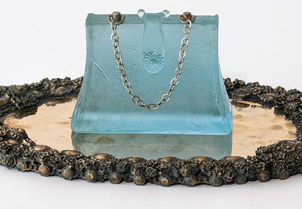<i>Deco</i>, 2024; Purse: 6 x 5 x 3 inches, Tray: 13 x 7 x 0.5 inches; glass, bronze, vintage chain, topaz