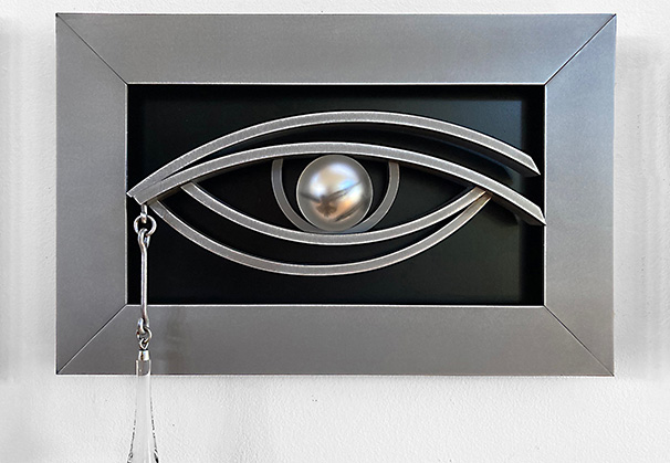 <i>Black Eye</i>, Framed, 2021; 17 h x 19.75 s x 6 d (inches); original image, screen-printed kiln-fired enamels, blown, sandblasted, mirrored glass, steel with patina and paint

