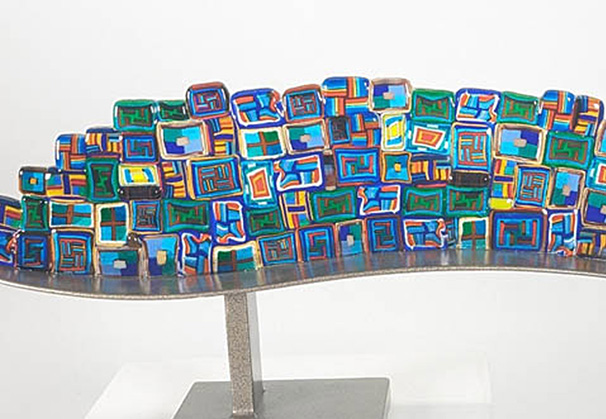 <i>Chromatic Fusion</i>, 2024; 8 x 19 x 3 inches; fused glass and steel