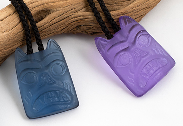 <i>Bear Pendants</i>, 2024; 2.5 x 2 x .5 inches; cast glass with hand woven waxed synthetic cordage