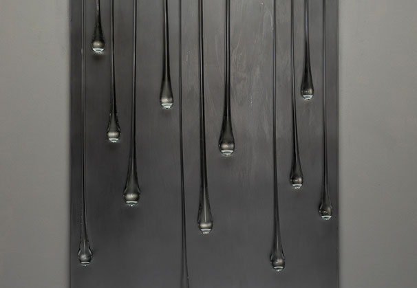 <i>It is Quiet and Still Here II</i>, 2026; 72 x 34 x 3 inches; Bent and etched Starfire glass with drops suspended on stainless steel. Photo by Richard Kelly
