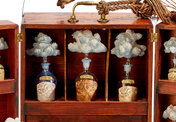 <i>Essence of Cloud Apothecary Box from H.M.S. Lucy, circa 1880</i>, 2021; 40 x 40 x 30 centimeters; handcrafted mahogany box, flame-sculpted, blown, and sandblasted borosilicate glass bottles, labels, scent, and tonic. Hand crafted apothecary box by Shane Wiechnik