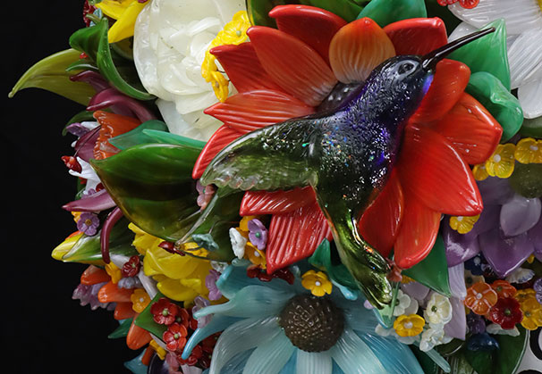 <i>Iconic Motors Logo</i>, 2024; 48 x 48 x 60 inches; hot sculpted glass and lampworked. This monumental commission transformed the client’s 2D logo into a 3D glass sculpture composed of thousands of meticulously crafted elements.