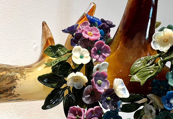 <i>Into the Wild</i>, 2025; 19 x 21 x 15 inches; hot sculpted, lampworked, and gilded glass, glass flowers by Erin Garmezy