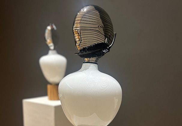 <i>Native Messenger I</i>, 2026; Blown, hot sculptured, etched, and mirrored glass, wood base
