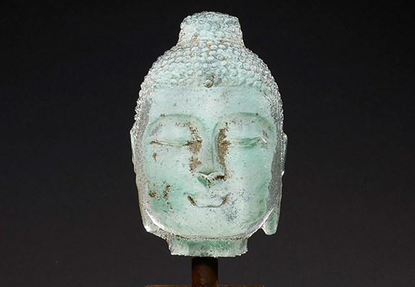 <i>Celadon Bookshelf Buddha</i>; 14 x 5 inches; sand cast glass with hand forged metal stand