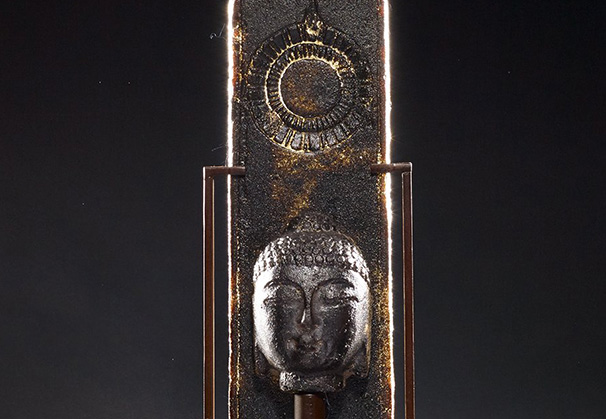 <i>Dark Amber Arrow Buddha</i>; 23 x 6 x 5 inches; sand cast glass and hand forged metal stand